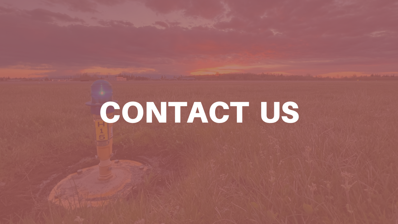 A blue runway light in a field with the sunset in the background with \"Contact Us\" superimpo…