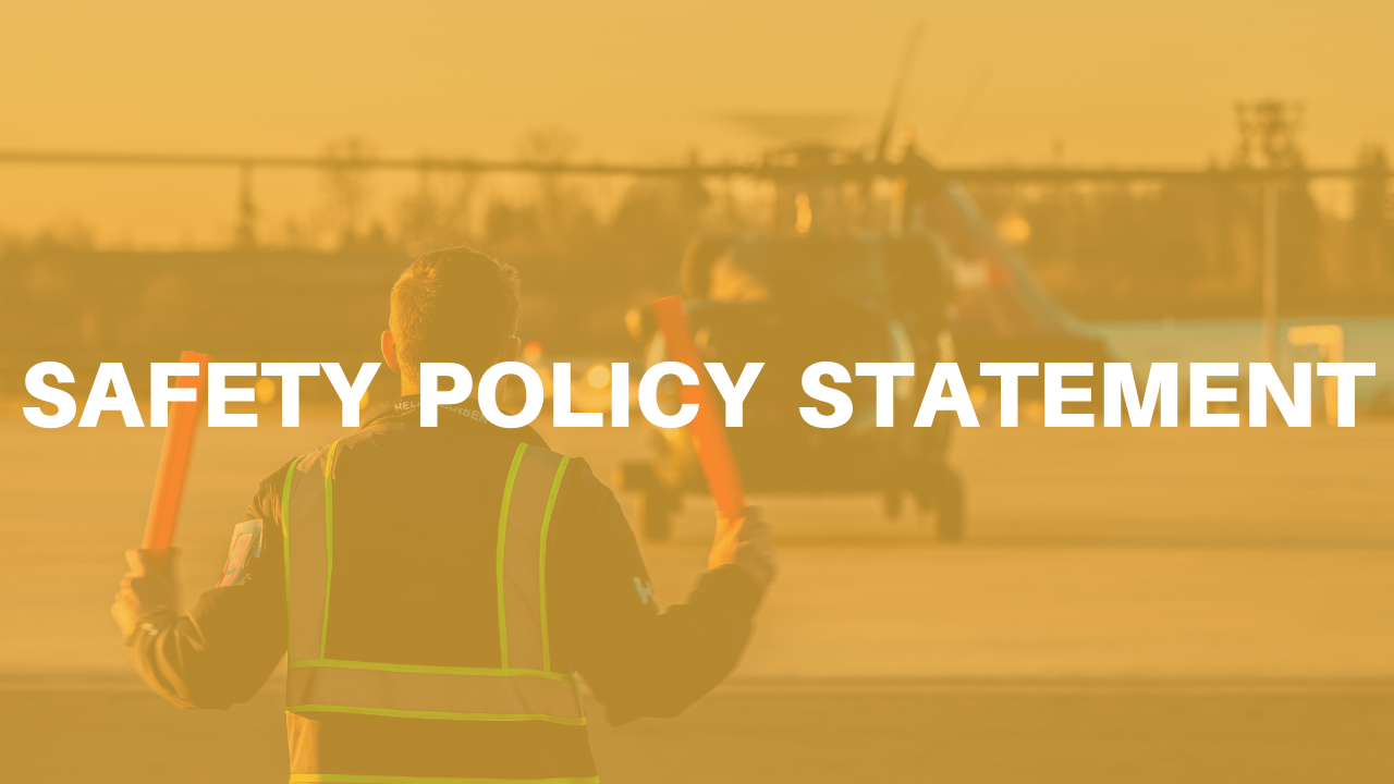 \"Safety Policy Statement\" superimposed on a worker directing aircraft using orange lighted w…