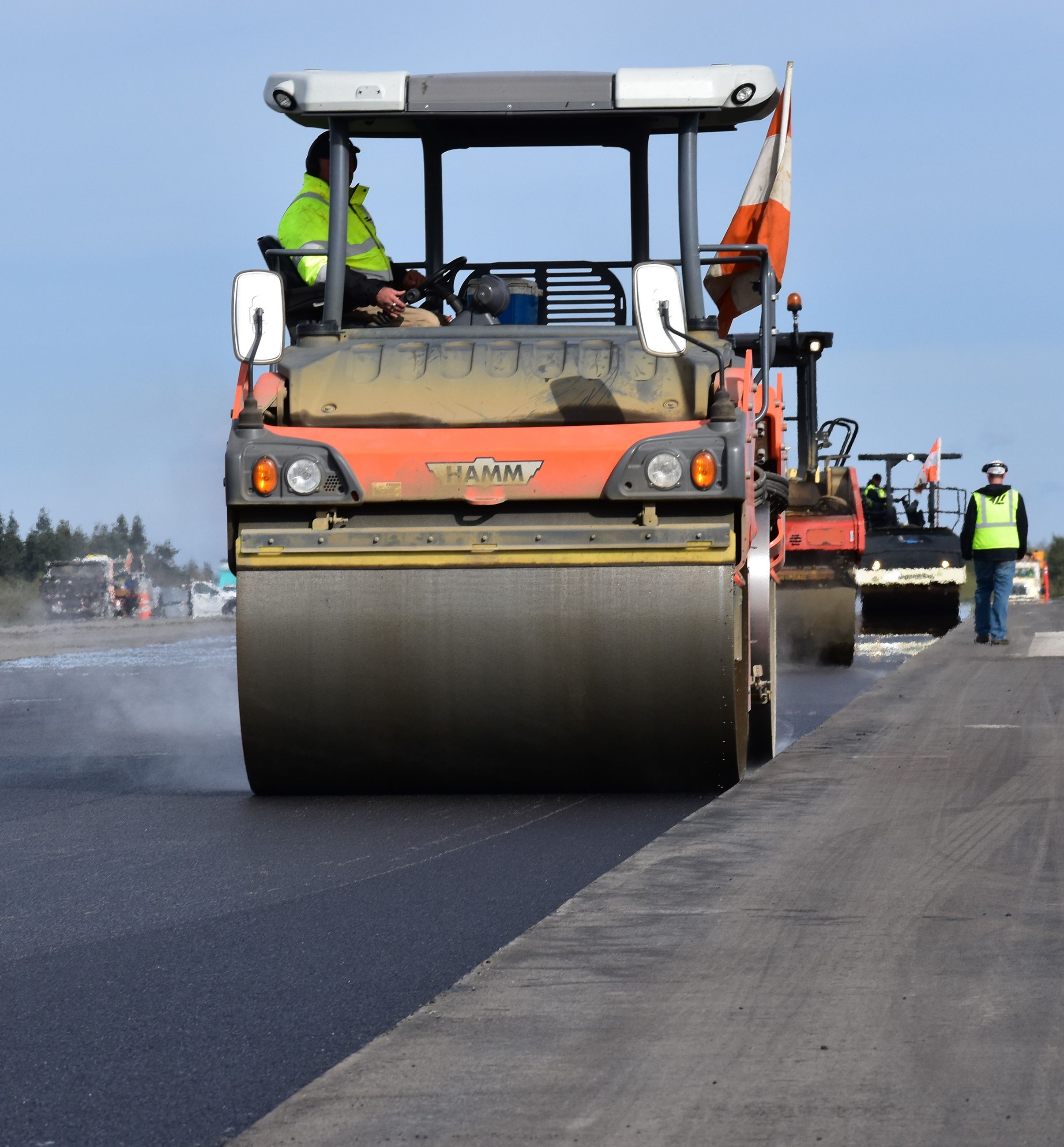 Roller compresses asphalt on runway October 3, 2018