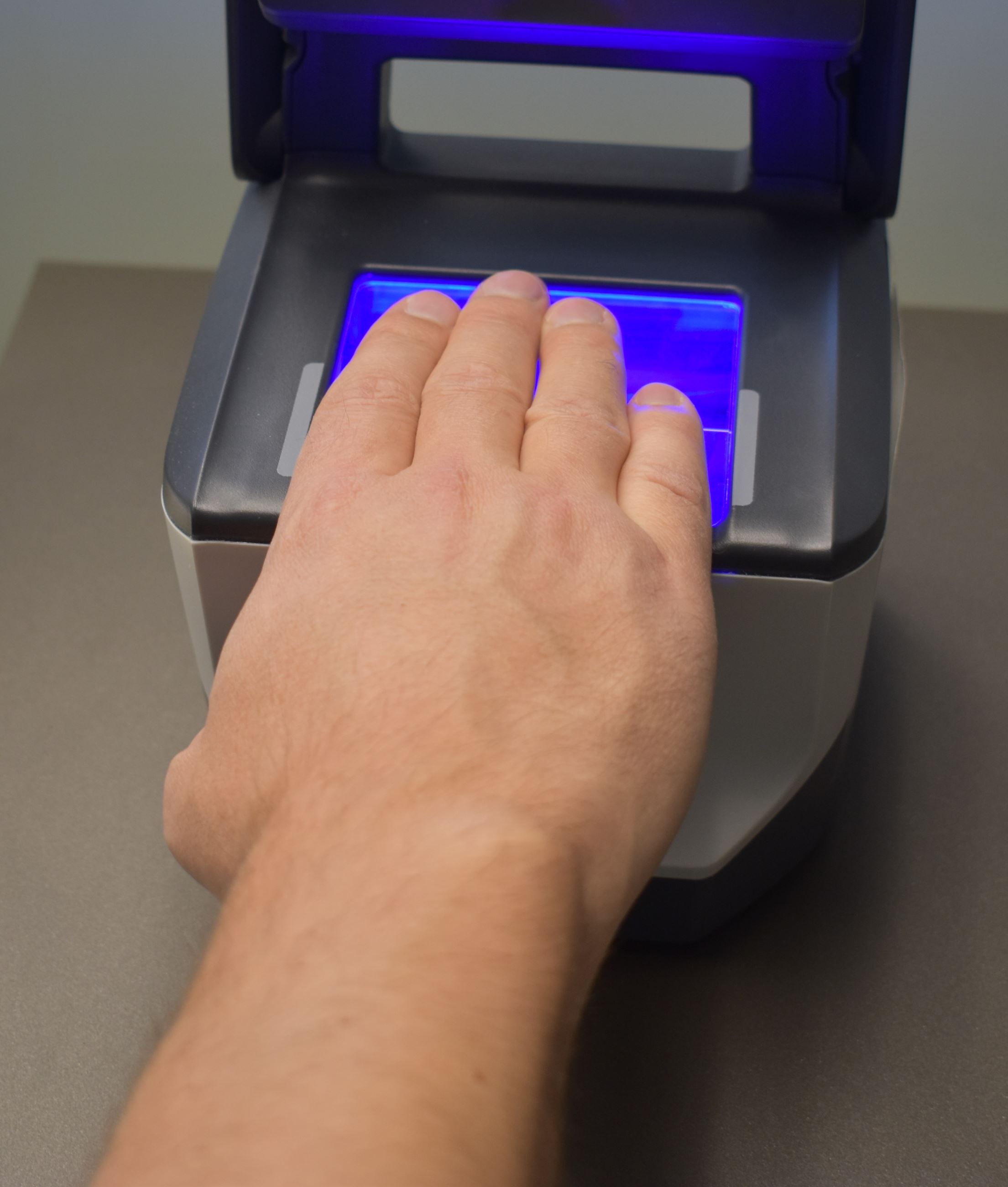 Hand on fingerprint machine